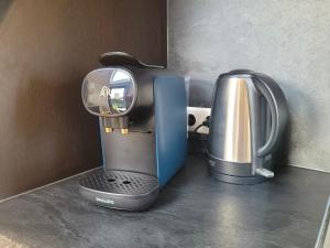 a coffee maker and a juicer sitting on a counter at Tiny Zen House in Heinkenszand with private sauna, airco, outdoor swimming pool, WiFi and 2 bedrooms in Heinkensand