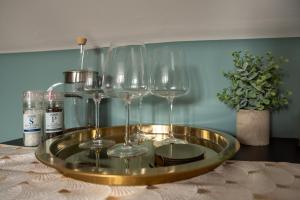 a tray with wine glasses on a table at CoHost - Sky high in Bristol in Bristol