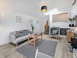 a living room with a couch and a table at 1 Bed in Sennen 93410 in Sennen