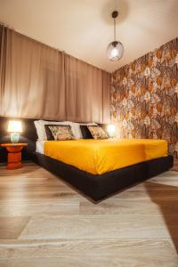 a bedroom with a bed with a yellow blanket at VL Luxury Apartment - Housea in Polignano a Mare