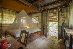 a room with a bed with a net in it at Bhakti Kutir in Palolem +37 photos