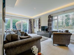 a living room with two couches and a television at 2 Bed in Mudeford 93458 in Christchurch