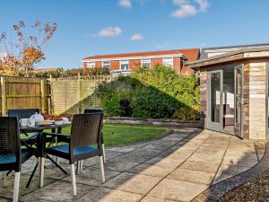 a patio with a table and chairs in a backyard at 3 Bed in Mudeford 93459 in Christchurch