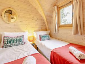 a room with two beds in a log cabin at 2 Bed in Sheinton 93397 in Leighton