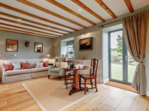 a living room with a table and a couch at 1 Bed in Riber 93436 in Matlock Bank