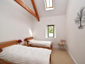 two beds in a room with two windows at 2 Bed in Blackdown Hills AONB 93402 in Luppitt