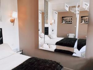Un ou plusieurs lits dans un hébergement de l'établissement Royal Hôtel