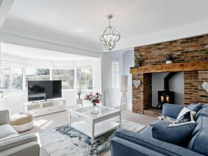 a living room with a couch and a fireplace at 3 Bed in Sutton on Sea SEALC in Sutton on Sea
