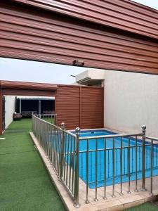 a swimming pool on the balcony of a house at استراحة وشاليه وقاعة السلطانه in Al-Salam