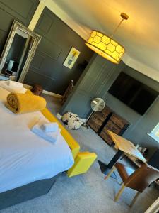 a bedroom with a bed and a dog in a room at The Plough Inn in Marsham
