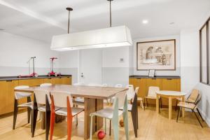 a kitchen and dining room with a wooden table and chairs at Midtown E 2br w elevator doorman gym nr UN NYC-752 in New York +33 photos