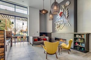 a living room with a fireplace and yellow chairs at Blueground First Hill gym nr green spaces SEA-707 in Seattle