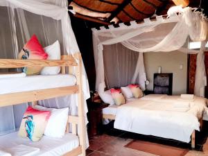 a bedroom with two bunk beds and a room with at Mukolo Cabins & Camping in Kongola