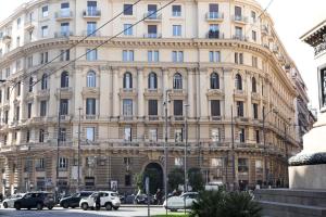 a large building with cars parked in front of it at Da Francesco in Naples