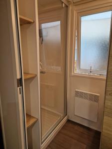 a walk in closet with a door and a window at Mobile Home For You les Pierres Couchées in Saint-Brevin-les-Pins
