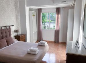 - une chambre avec un lit et 2 serviettes dans l'établissement Luninoso y práctico apartamento en el centro, à Grenade