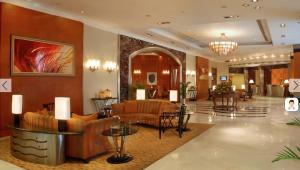 a lobby of a hotel with couches and tables at The Manohar Hyderabad in Hyderabad