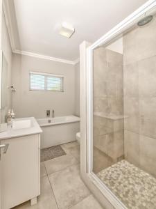 a bathroom with a shower and a toilet and a sink at 82 on Main in Agulhas