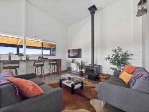 a living room with two couches and a stove at Rosa Glen Retreat - Margaret River in Rosa Glen