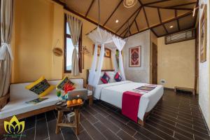 a bedroom with a bed and a couch at Hanasa Pu Luong Resort in Pu Luong