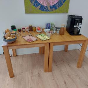 a wooden table with food on top of it at Pension am Bach in Stützerbach