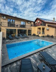 a swimming pool in front of a house at Стоичковата къща гр. Стрелча in Strelcha