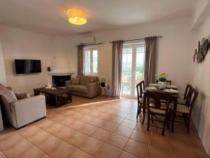 a living room with a table and a dining room at Krios Guesthouse in Krotiri