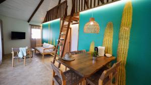 a dining room with a wooden table and a green wall at EL DELFÍN VERDE RESORTS - Platja d'Aro in Platja  d'Aro