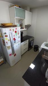 a kitchen with a refrigerator with magnets on it at Santiago in Paraná