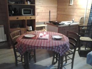 a kitchen with a table with a table cloth on it at Le Repaire de Mitzerlé in Mitzach