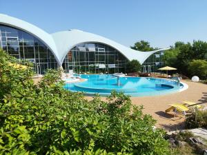 a large building with a large swimming pool at Hotel an der Therme Bad Sulza in Bad Sulza