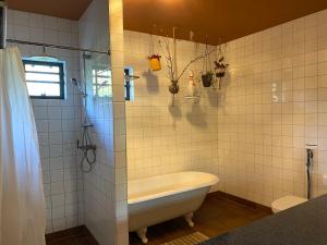a bathroom with a tub and a toilet and a shower at Stay Classy in Otterlo