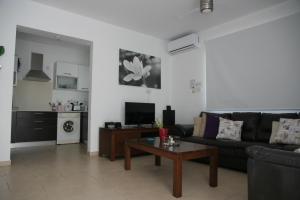 a living room with a couch and a coffee table at Pedalion Villa in Protaras