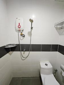 a bathroom with a shower and a toilet at The 60 in George Town