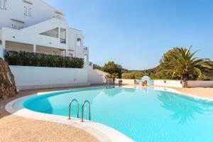 a swimming pool in front of a building at Dos Geckos - Son Parc in Son Parc