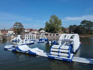 a row of inflatable water slides in the water at 3-Bed homely modern caravan in Clacton-on-Sea in Clacton-on-Sea