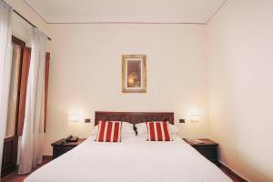 Postel nebo postele na pokoji v ubytování Hotel Galileo