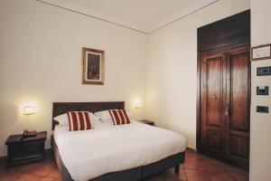 Postel nebo postele na pokoji v ubytování Hotel Galileo