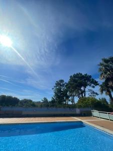 a swimming pool with a blue sky in the background at Lanzada Apartments in Sanxenxo