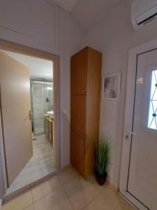 a room with a hallway with a cabinet and a mirror at CITY CENTER APARTMENT in Sparta