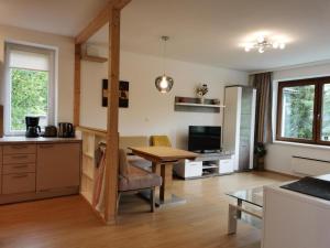 a kitchen and living room with a table and a dining room at Haus Gerhild in Velden am Wörthersee