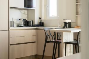 a small kitchen with a table and two chairs at Santa Tecla Living Certosa 133 in Milan