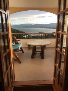 a view from a door of a balcony with a table at Estupendo Apartamento Mediterráneo in Faro de Cullera