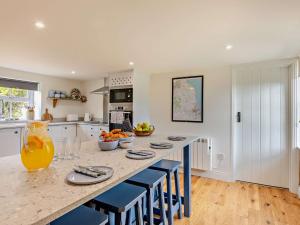 a kitchen with a large table with chairs and oranges on it at 2 Bed in Warkworth 93337 in Acklington