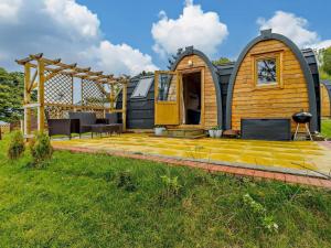 a tiny house with a deck in a yard at 2 Bed in Sheinton 93396 in Leighton