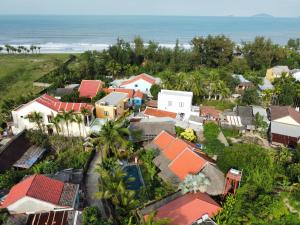 an aerial view of a town with houses and the ocean at Pao Homes - An Bang Beach Stone Villa in An Bàn (2)