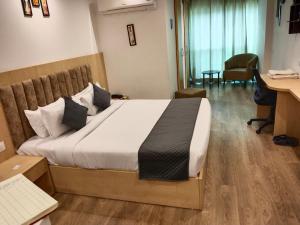 a bedroom with a large bed in a room with a desk at The sky luxury home stay in Jaipur