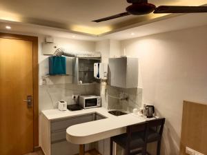 a small kitchen with a counter and a microwave at The sky luxury home stay in Jaipur