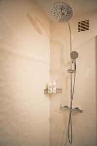a shower with a shower head in a bathroom at htop Amatista #htopBliss in Lloret de Mar