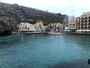 a large body of water with buildings and buildings at Xlendi Home in Xlendi